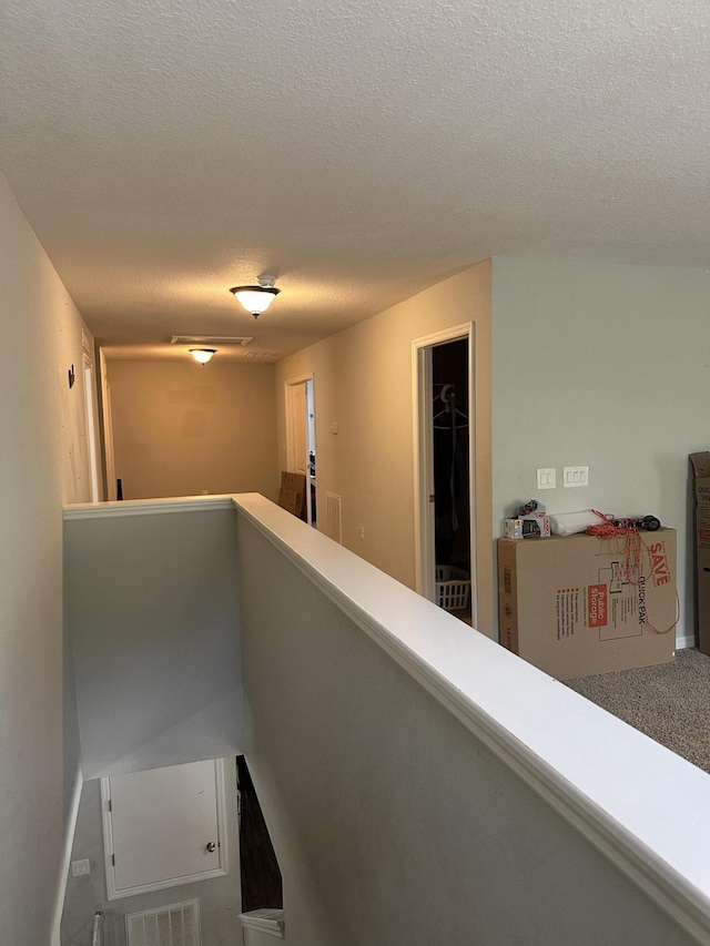 6101 NW Painted Bunting Ct, Port Saint Lucie, FL 34986 - hall with an upstairs landing and a textured ceiling
