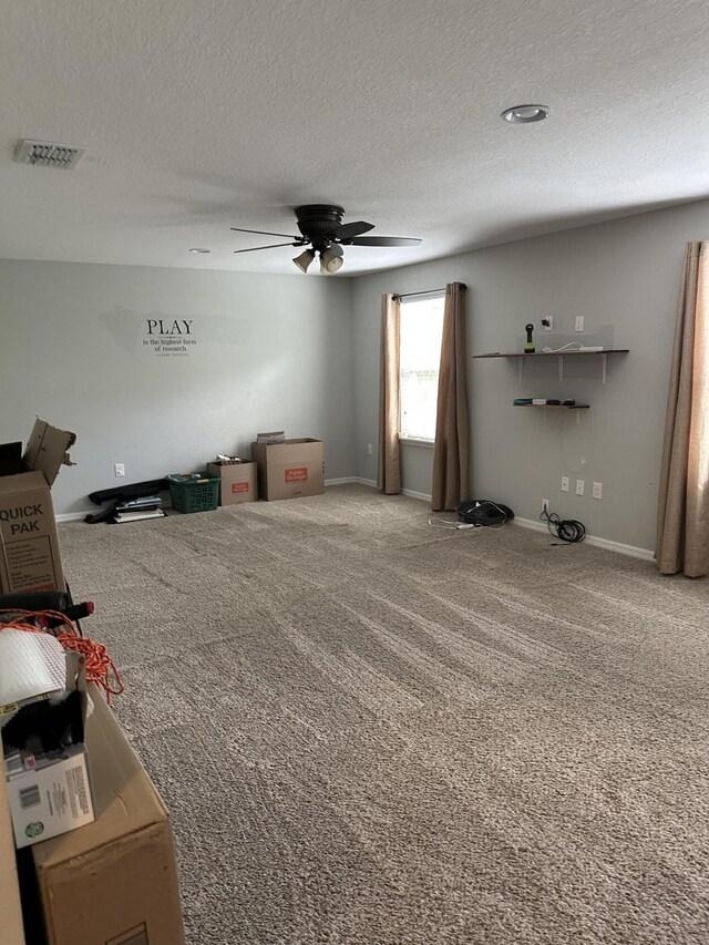 6101 NW Painted Bunting Ct, Port Saint Lucie, FL 34986 - unfurnished living room featuring carpet flooring, ceiling fan, a textured ceiling, and baseboards