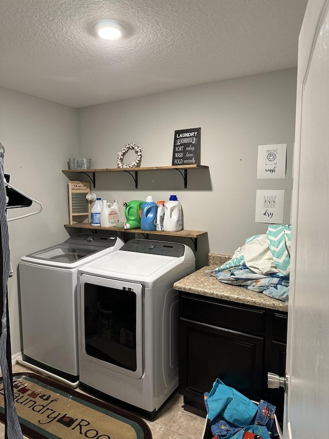 6101 NW Painted Bunting Ct, Port Saint Lucie, FL 34986 - laundry area featuring independent washer and dryer, a textured ceiling, and cabinet space
