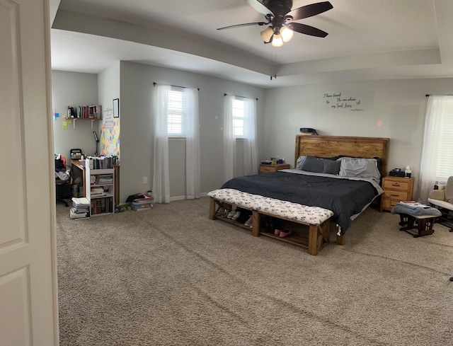 6101 NW Painted Bunting Ct, Port Saint Lucie, FL 34986 - carpeted bedroom with a raised ceiling and ceiling fan