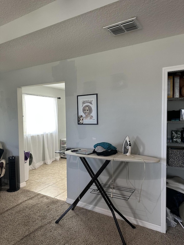6101 NW Painted Bunting Ct, Port Saint Lucie, FL 34986 - office area with baseboards, a textured ceiling, light colored carpet, and light tile patterned floors
