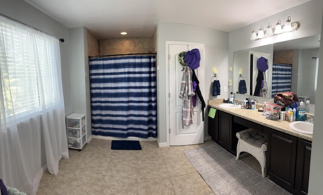 6101 NW Painted Bunting Ct, Port Saint Lucie, FL 34986 - bathroom with double vanity, a shower with shower curtain, tile patterned floors, and baseboards