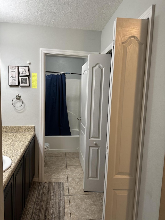 6101 NW Painted Bunting Ct, Port Saint Lucie, FL 34986 - full bathroom featuring toilet, vanity, a textured ceiling, shower / tub combo with curtain, and tile patterned flooring