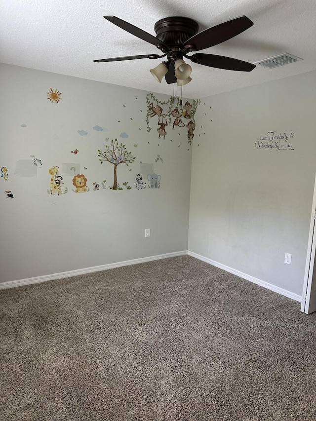 6101 NW Painted Bunting Ct, Port Saint Lucie, FL 34986 - spare room featuring carpet flooring, a ceiling fan, baseboards, and a textured ceiling