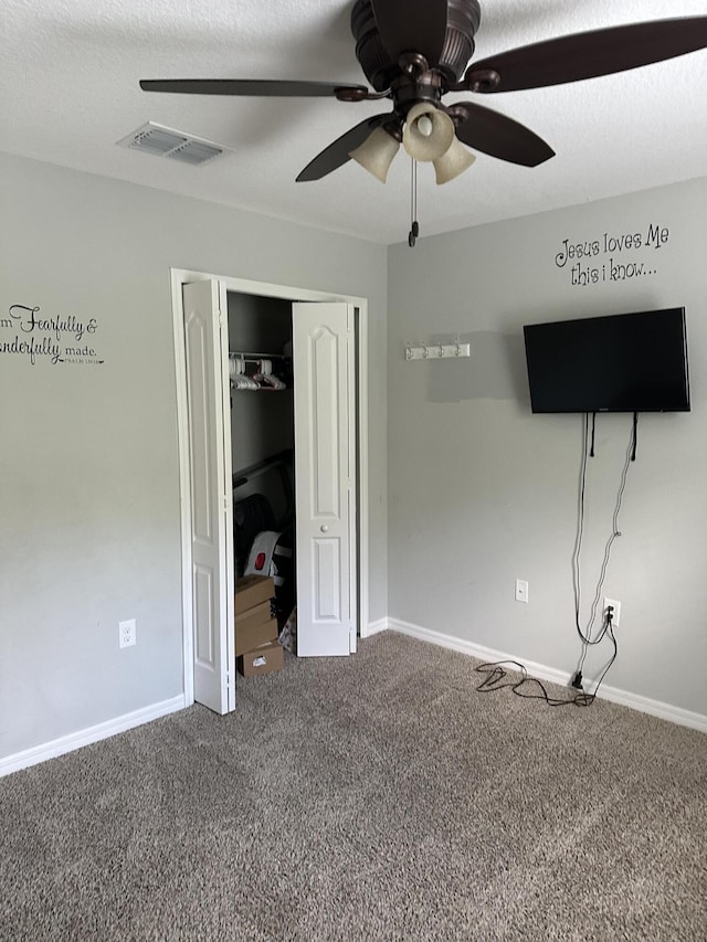 6101 NW Painted Bunting Ct, Port Saint Lucie, FL 34986 - unfurnished bedroom featuring carpet, a closet, baseboards, and a ceiling fan