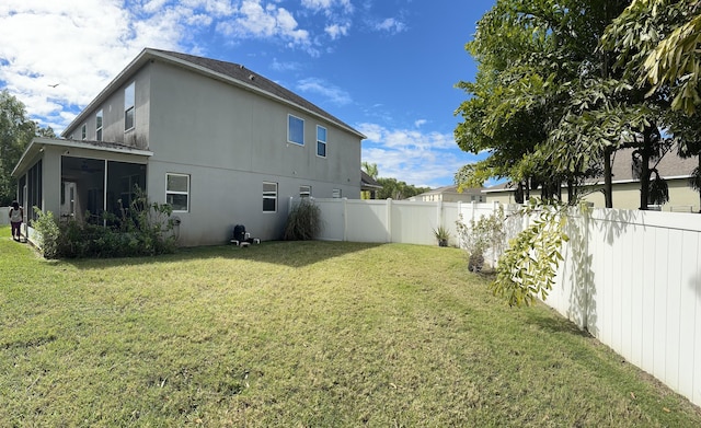 6101 NW Painted Bunting Ct, Port Saint Lucie, FL 34986 - rear view of property with stucco siding and a sunroom