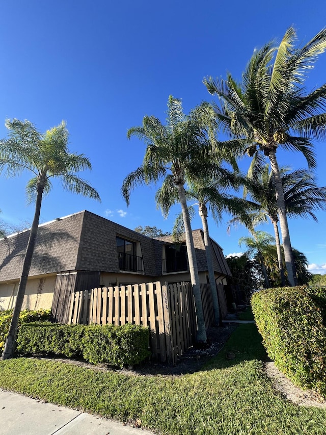 view of side of property with a shingled roof