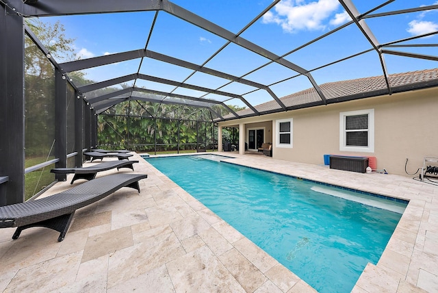 271 Rudder Cay Way, Jupiter, FL 33458 - pool at dusk featuring glass enclosure, a patio area, and an outdoor pool