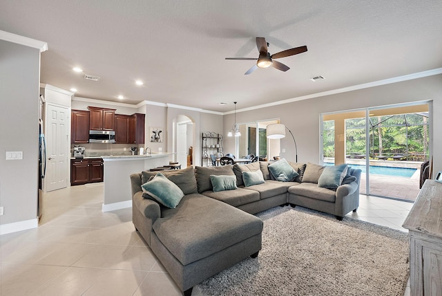 271 Rudder Cay Way, Jupiter, FL 33458 - living area with crown molding, arched walkways, baseboards, and ceiling fan with notable chandelier