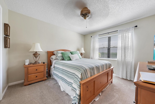 bedroom with light colored carpet, ceiling fan, a textured ceiling, and baseboards