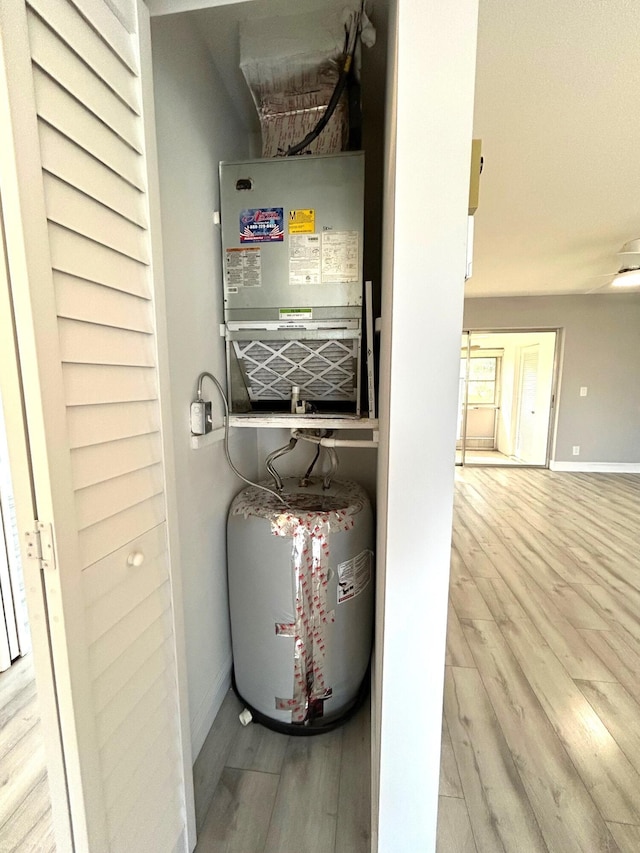 utility room featuring water heater