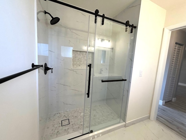 full bath featuring marble finish floor, baseboards, and a marble finish shower