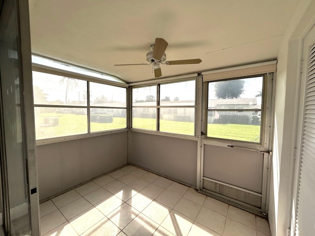 unfurnished sunroom featuring a ceiling fan