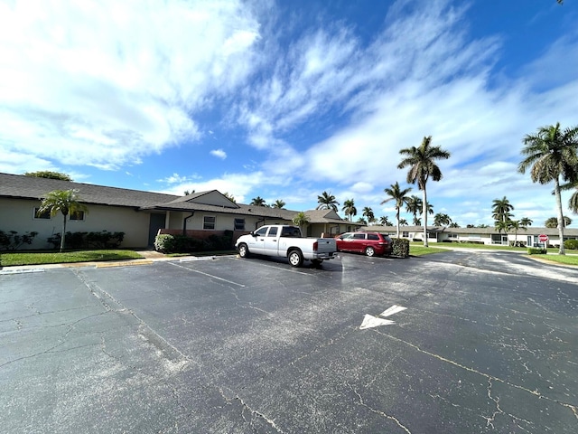 uncovered parking lot featuring a residential view