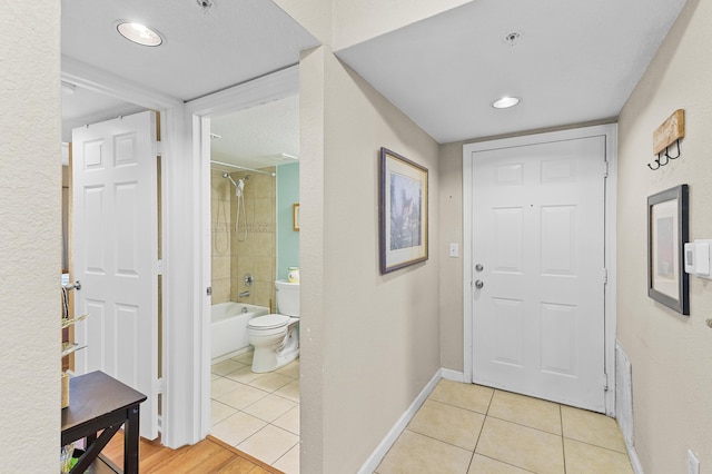 interior space featuring light tile patterned floors and baseboards