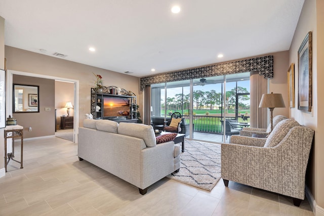 living room with recessed lighting, a sunroom, visible vents, and baseboards