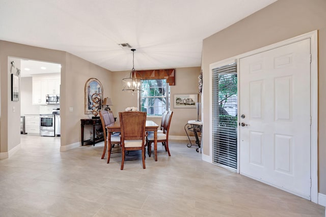 dining room featuring a chandelier, baseboards, visible vents, and a healthy amount of sunlight
