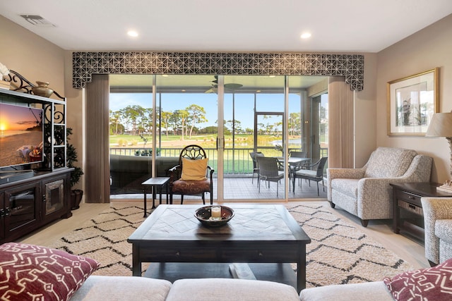 living room featuring a healthy amount of sunlight, light wood-style flooring, visible vents, and recessed lighting