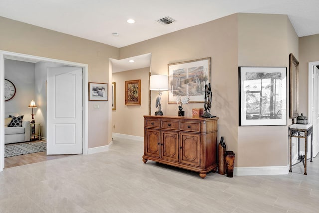 corridor featuring recessed lighting, visible vents, and baseboards