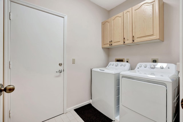 laundry area with cabinet space, washer and clothes dryer, baseboards, and light tile patterned floors