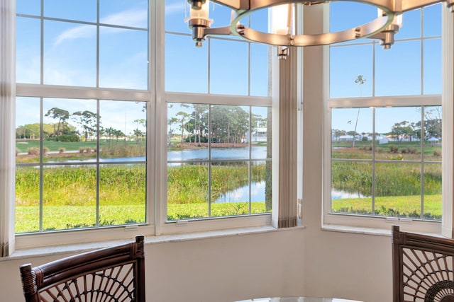 room details featuring a water view and a notable chandelier
