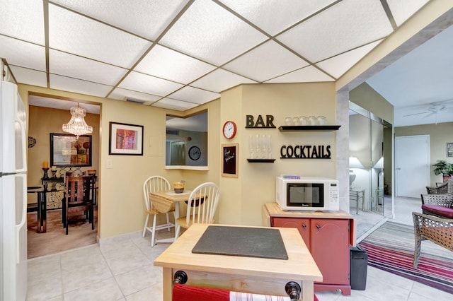 game room with a paneled ceiling, light tile patterned floors, ceiling fan, and visible vents