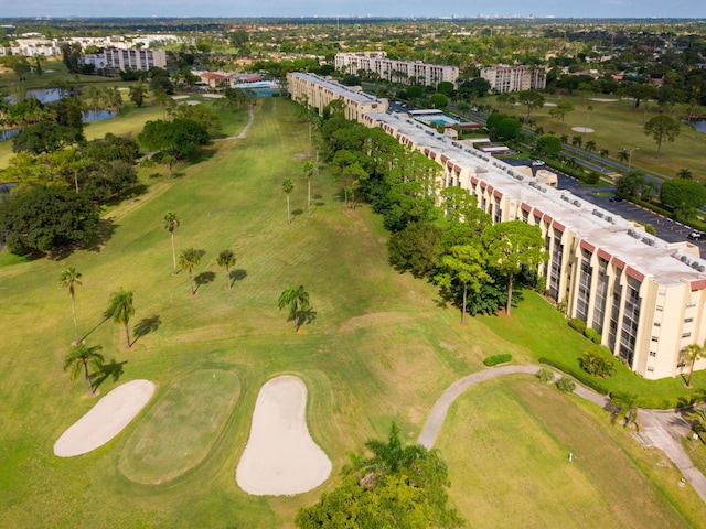 aerial view featuring golf course view and a water view