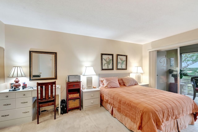 bedroom featuring light colored carpet and access to exterior