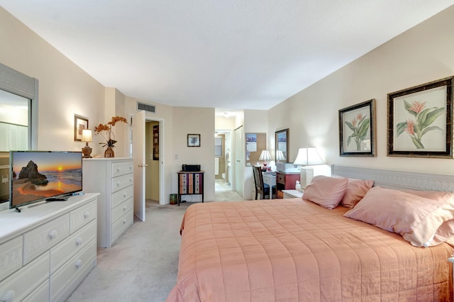 bedroom featuring connected bathroom, visible vents, and light colored carpet