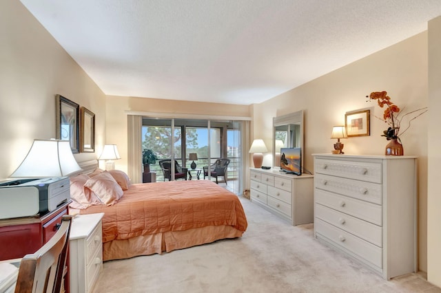 bedroom with light carpet, a textured ceiling, and access to exterior