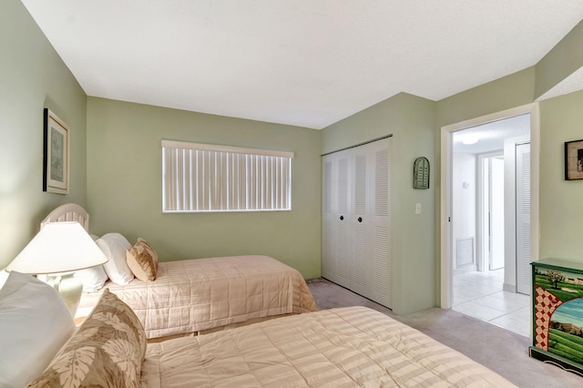 bedroom with light carpet, visible vents, and a closet