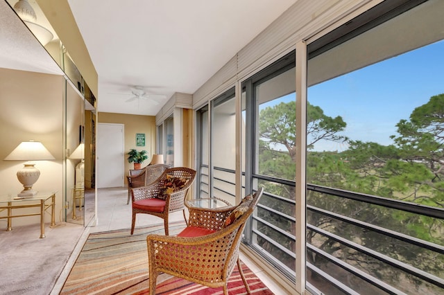 sunroom / solarium featuring ceiling fan