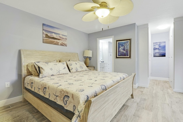 bedroom with connected bathroom, ceiling fan, baseboards, and wood finished floors