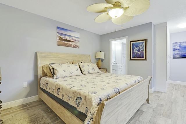 bedroom featuring ensuite bath, ceiling fan, baseboards, and wood finished floors