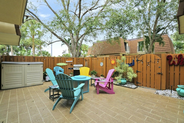 view of patio / terrace featuring a gate, fence, and area for grilling