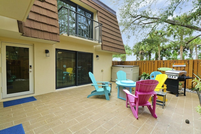 view of patio / terrace featuring fence and grilling area