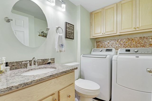 half bath featuring tasteful backsplash, washer and dryer, vanity, and toilet