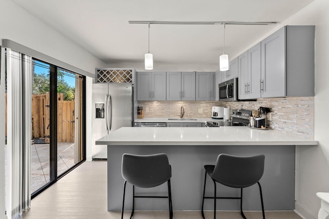 9965 NW 6th Ct, Plantation, FL 33324 - kitchen featuring stainless steel appliances, gray cabinets, a sink, and a peninsula