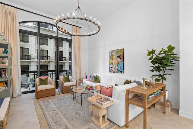 interior space with a towering ceiling, light tile patterned floors, and baseboards