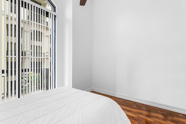 bedroom featuring access to exterior, ceiling fan, baseboards, and wood finished floors