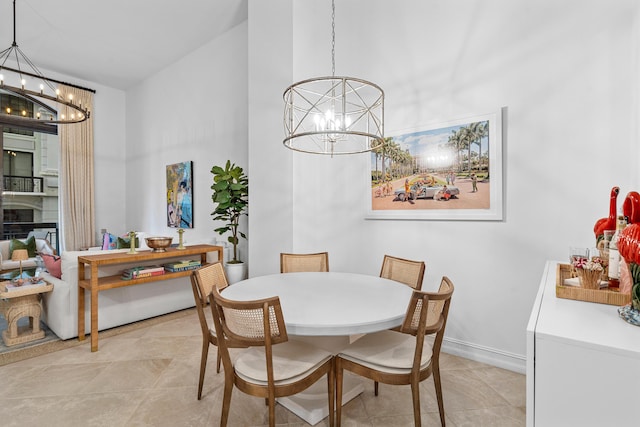 dining area with light tile patterned floors, a fireplace, baseboards, and a notable chandelier