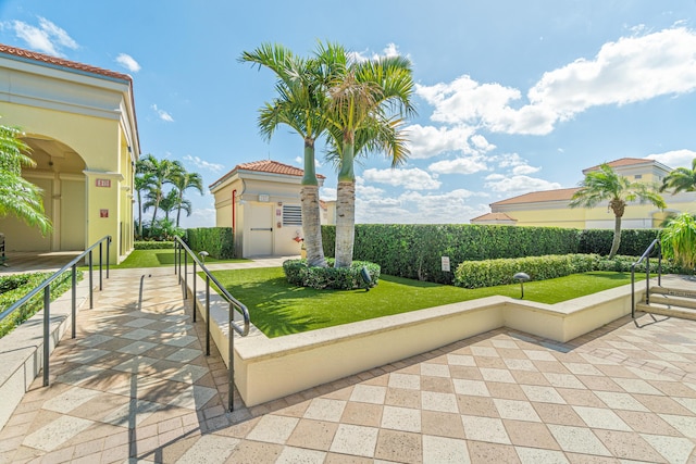 view of home's community with a yard and a patio area