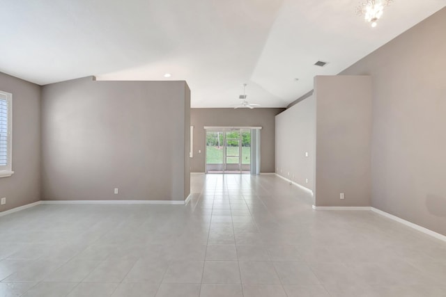 unfurnished room featuring lofted ceiling, light tile patterned floors, ceiling fan, and baseboards