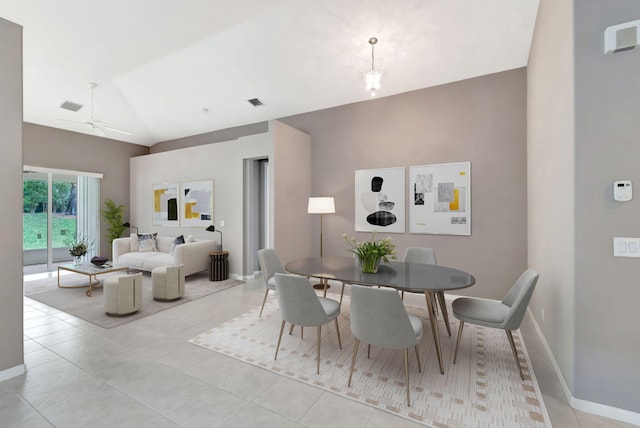 dining space featuring light tile patterned floors, baseboards, visible vents, vaulted ceiling, and ceiling fan with notable chandelier