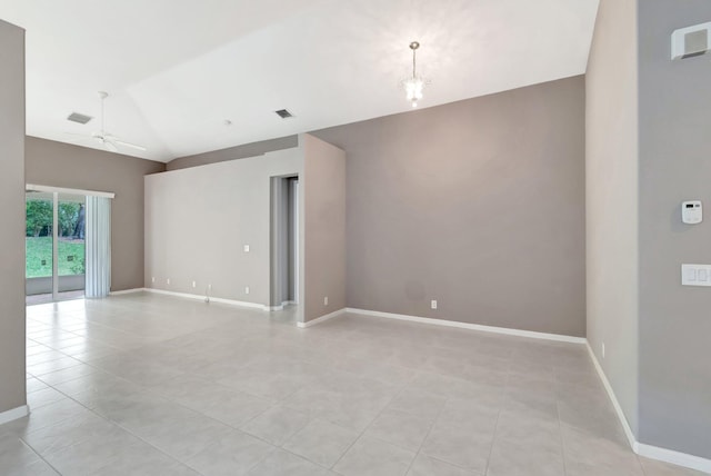 empty room featuring light tile patterned floors, ceiling fan with notable chandelier, visible vents, baseboards, and vaulted ceiling