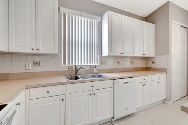 kitchen featuring white dishwasher, stove, a sink, white cabinetry, and light countertops