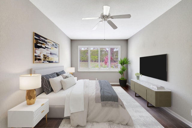 bedroom featuring ceiling fan, baseboards, and wood finished floors