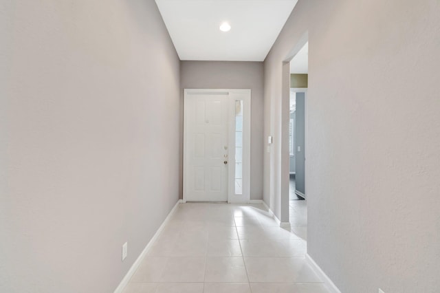 entryway featuring light tile patterned floors and baseboards