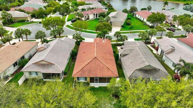 drone / aerial view with a water view and a residential view