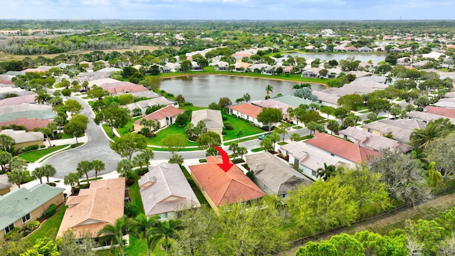 drone / aerial view featuring a water view and a residential view